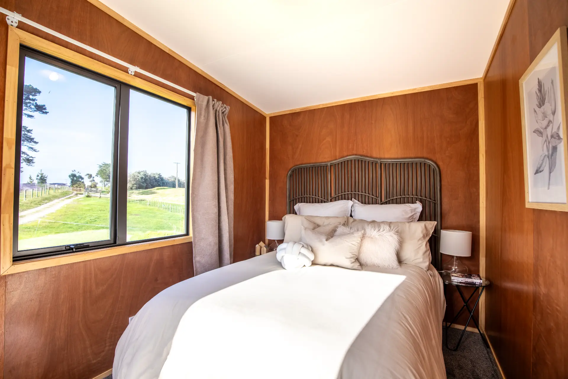 Outaspace 12 OutaSpace cabin furnished as a bedroom, with a double bed beside a large window